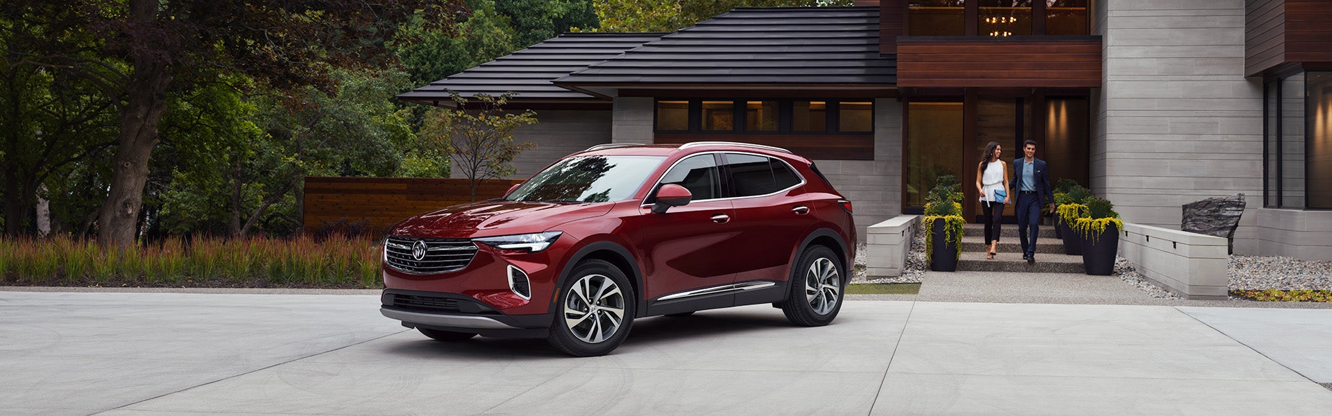 A red Buick parked in front of a house